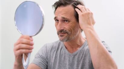 Man examining hair loss